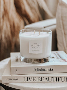Candle on a stack of books with a soft blurred background