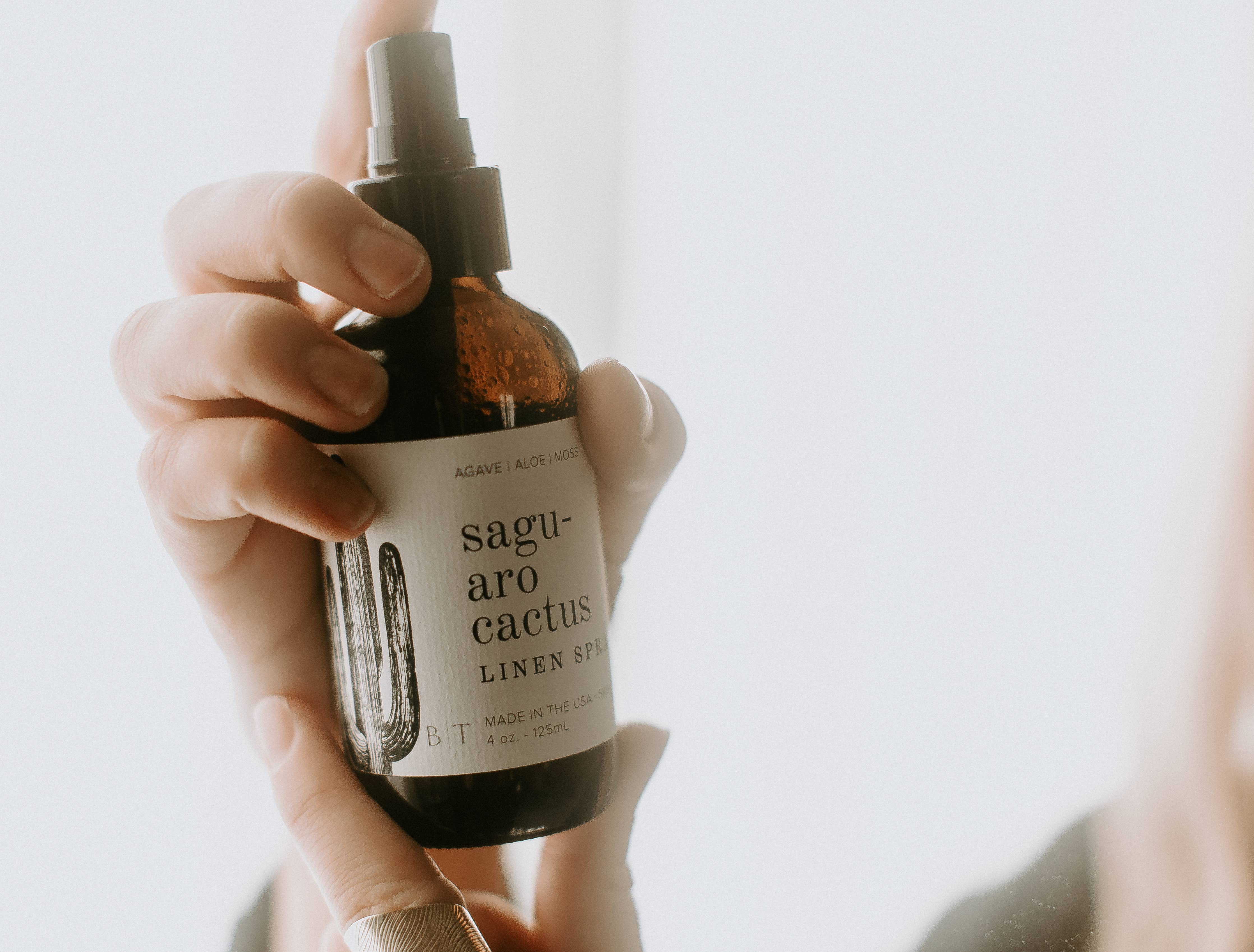 linen spray in hand