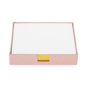 A pink canvas desk jotter with a gold foil label sits on a white background.