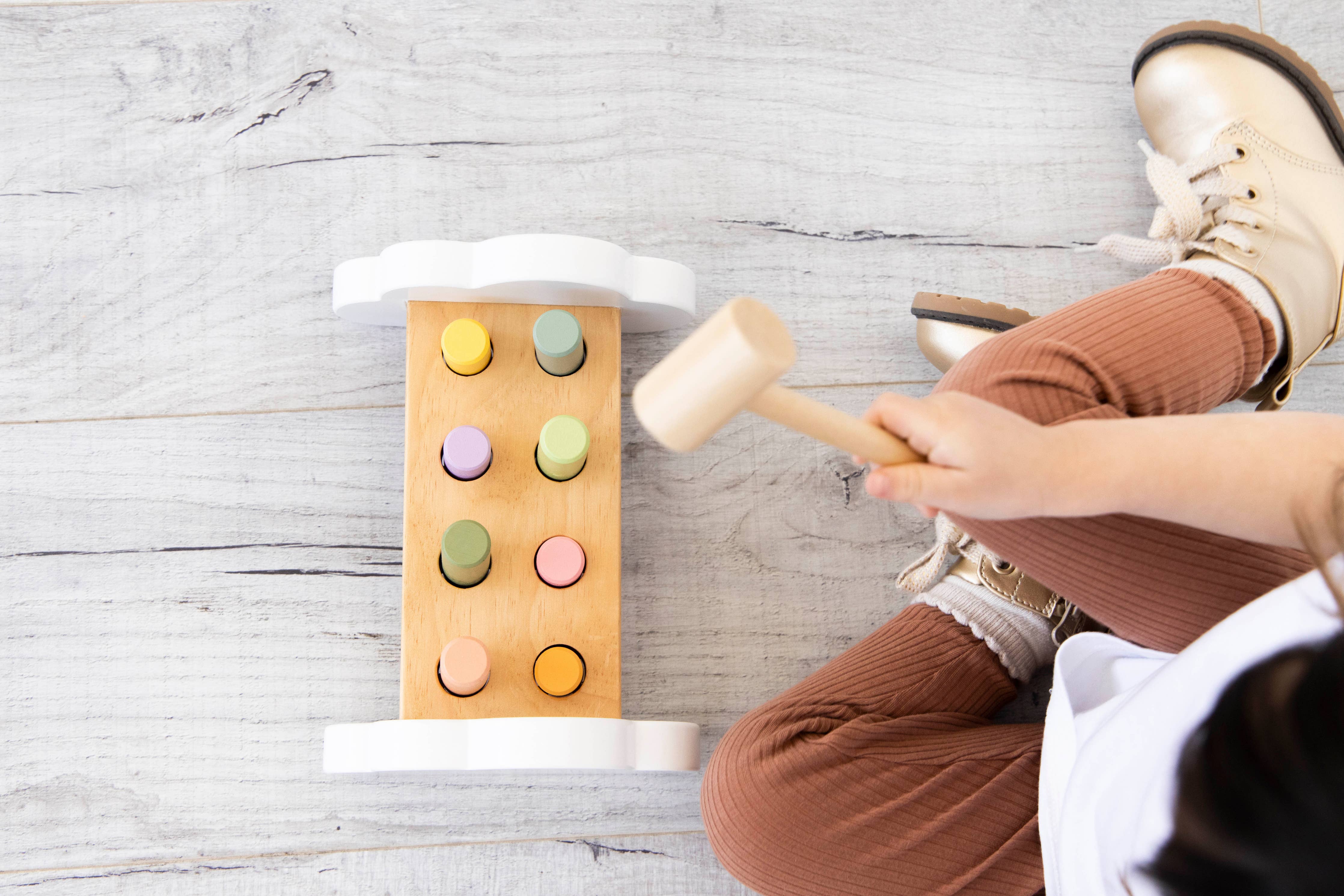 birds eye view of hammer bench toy & child playing with the toy