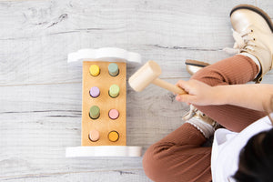birds eye view of hammer bench toy & child playing with the toy