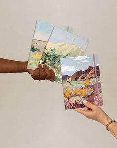 hands holding notebooks