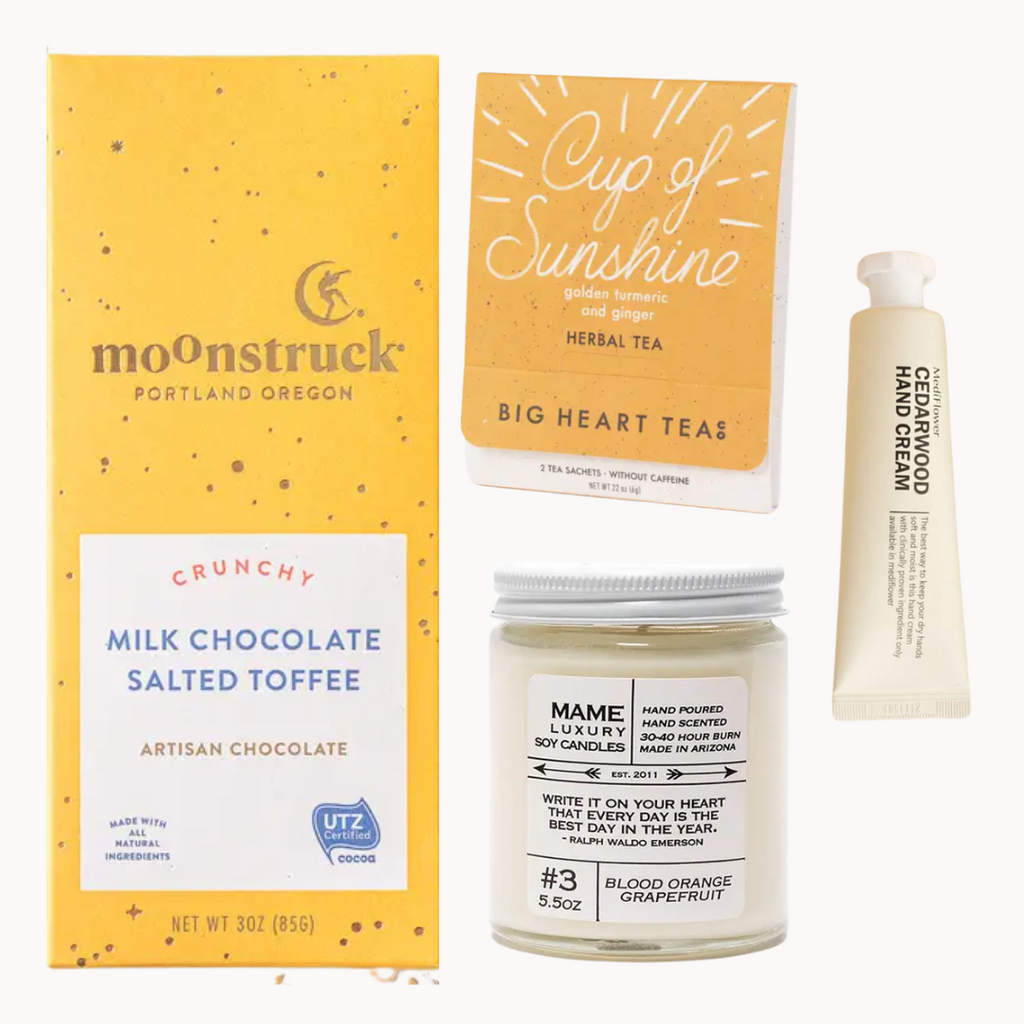 wellness gift box with chocolate, tea, candle, and hand lotion