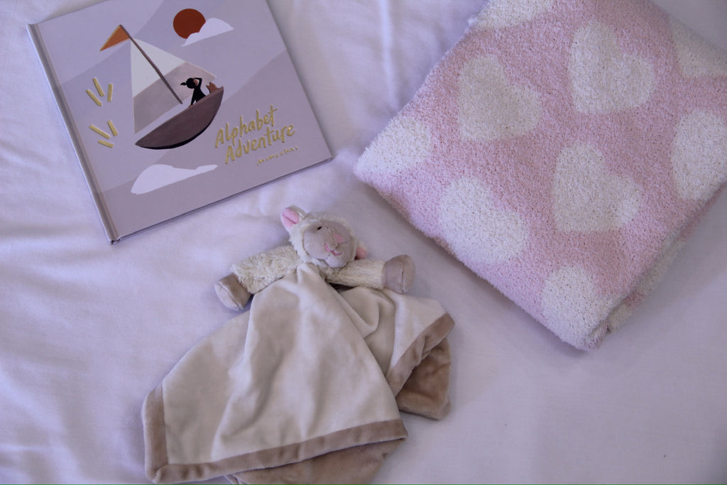 alphabet adventure book, lamb comforter, pink heart printed blanket