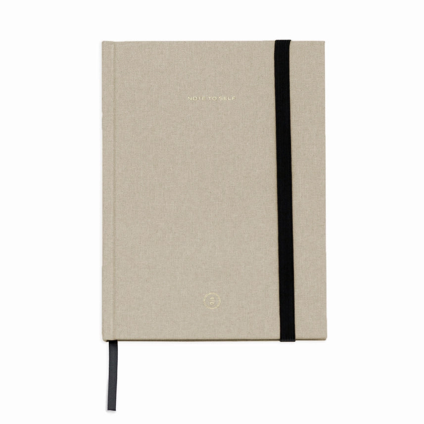 cream lined note pad closed
