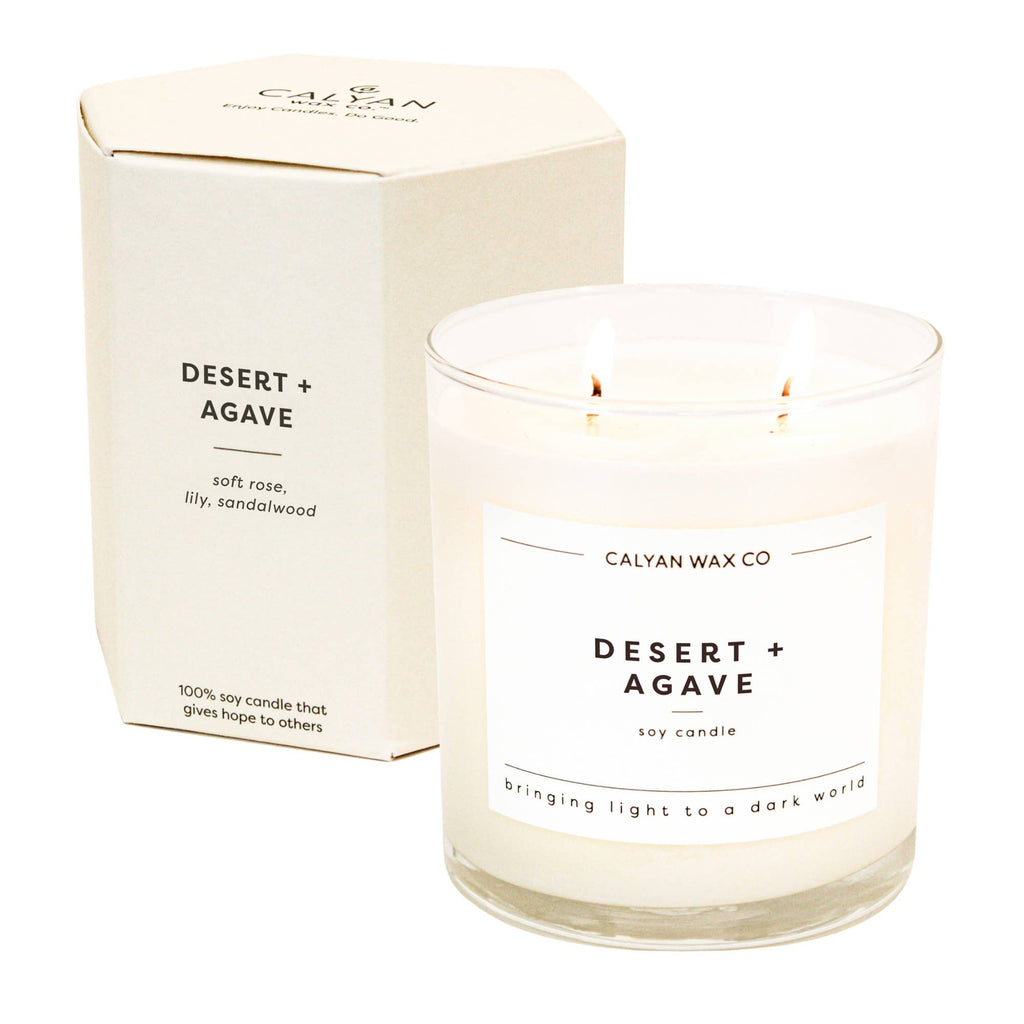 Candle labeled 'Desert + Agave' by Calyan Wax Co with packaging on a white background