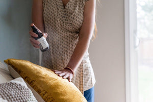 woman spraying linen spray