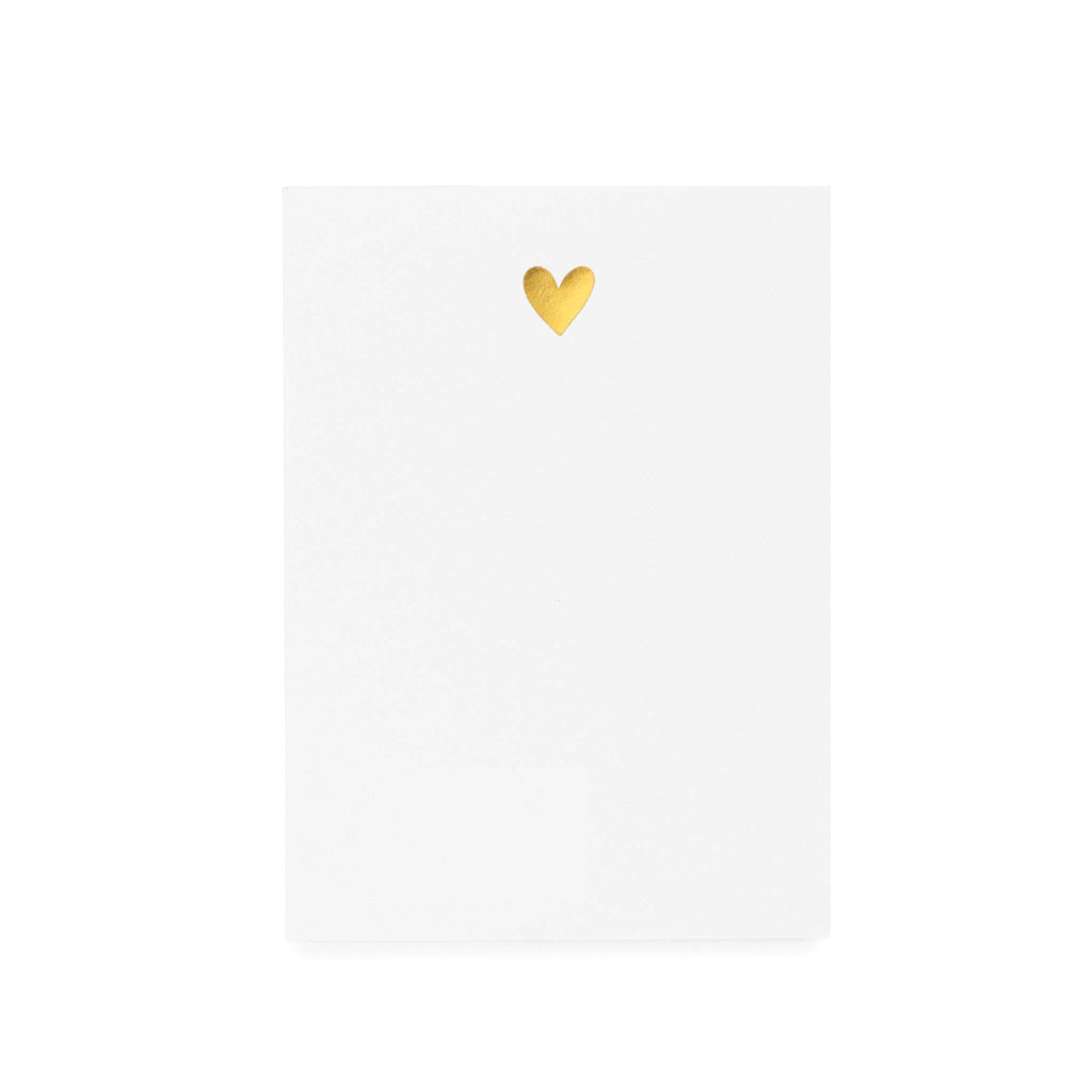 Blank white notepad with a gold heart in the center.