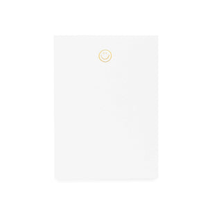 Blank white notebook with a yellow smiley face in the center.